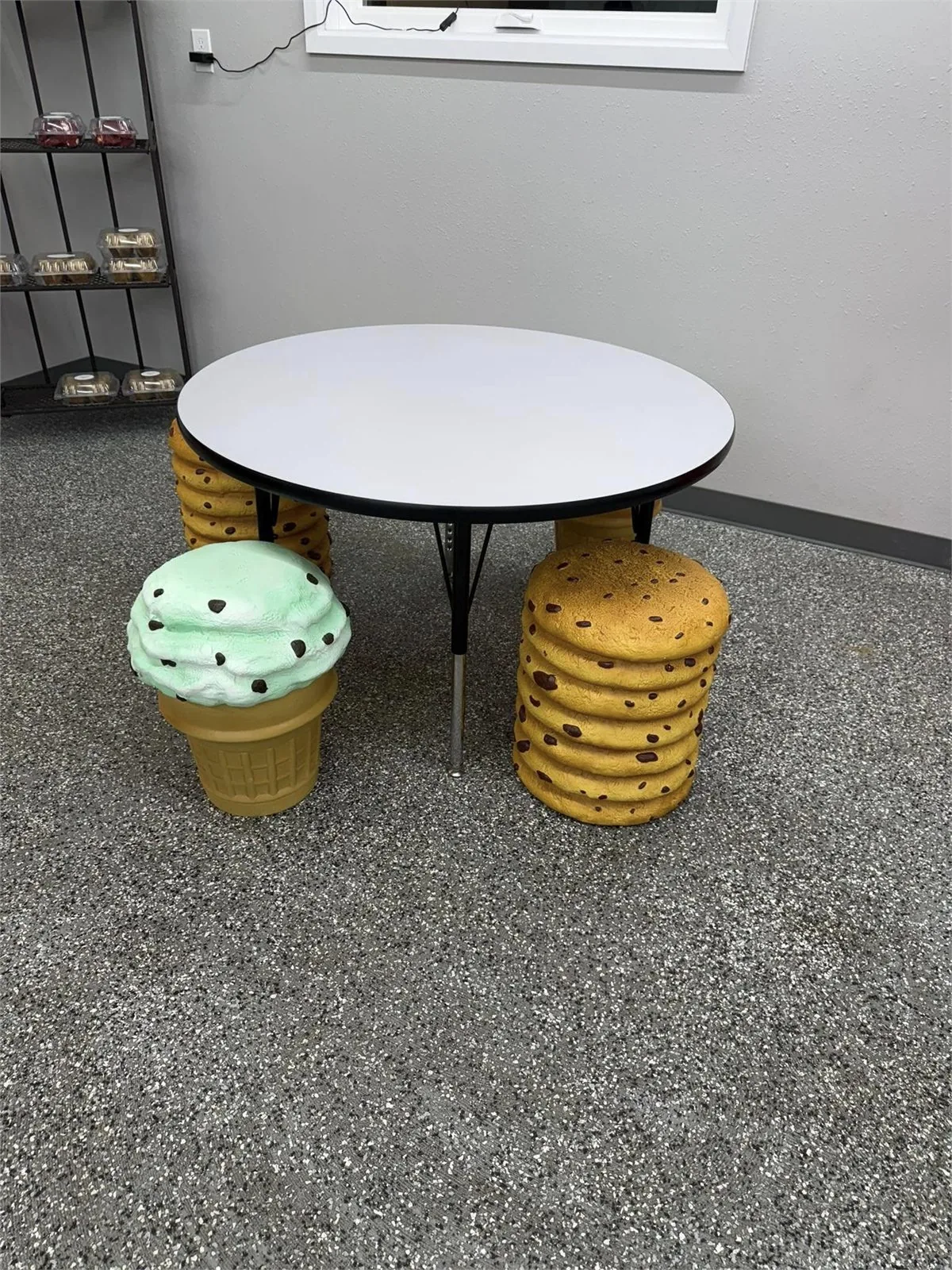 Ice cream cone and cookie stools around a table at Udderly Delicious